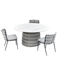 View of a modern round dining set featuring a white marble - like table top, woven table base, and three chairs with woven backs, light gray cushions, and black metal legs, suitable for outdoor or indoor use.