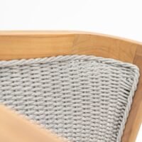 Close-up of outdoor teak armchair with rope weave backrest, stable frame, water-resistant cushions, easy to maintain, elegant in garden
