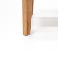 close-up of outdoor teak armchair, teak frame with natural texture, stable and weather-resistant