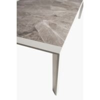 Outdoor Ethan marble dining table detail, showing marble texture and precise top-to-frame connection.